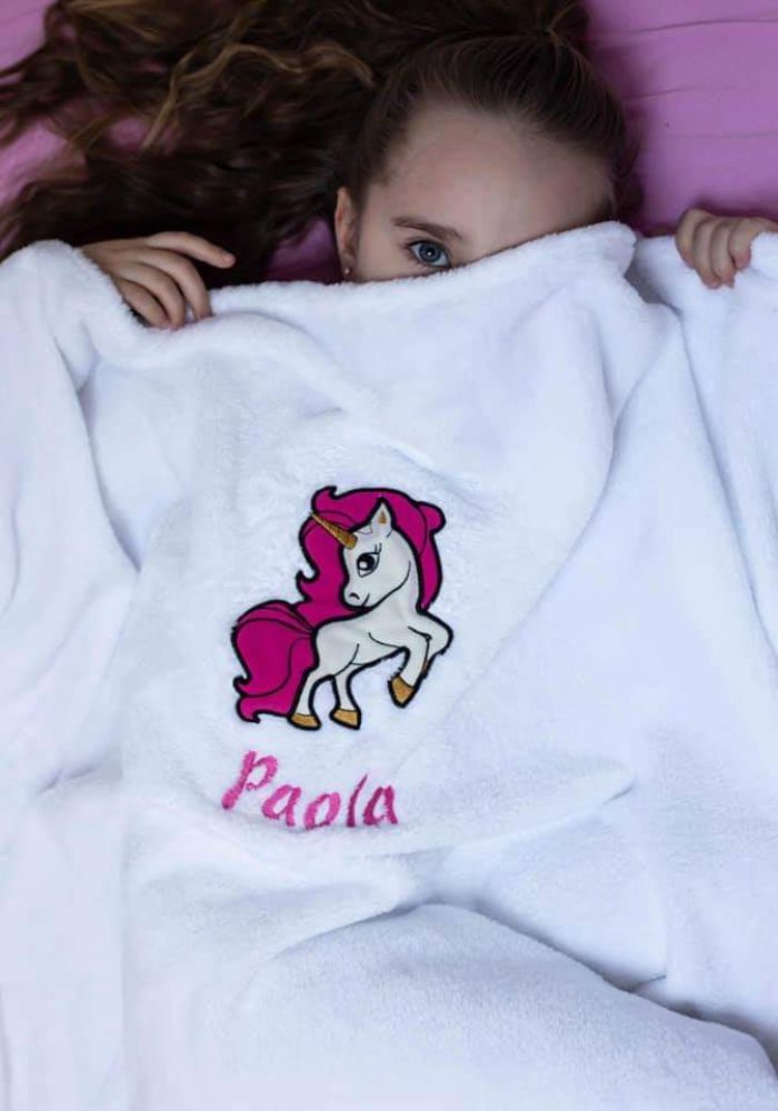 Little girl with a white personalized blanket
