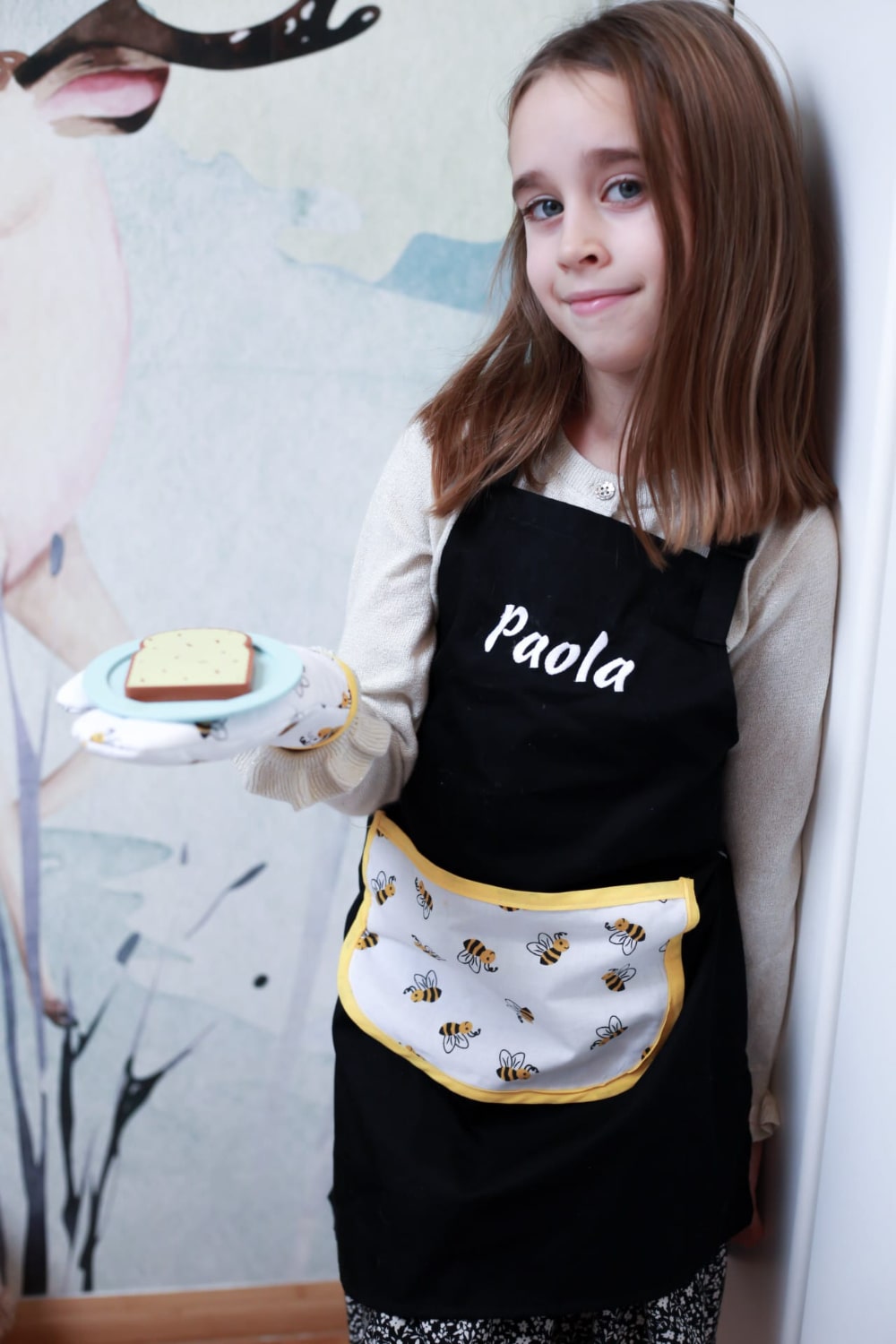 Young girl enjoying her personalized apron and oven mitt