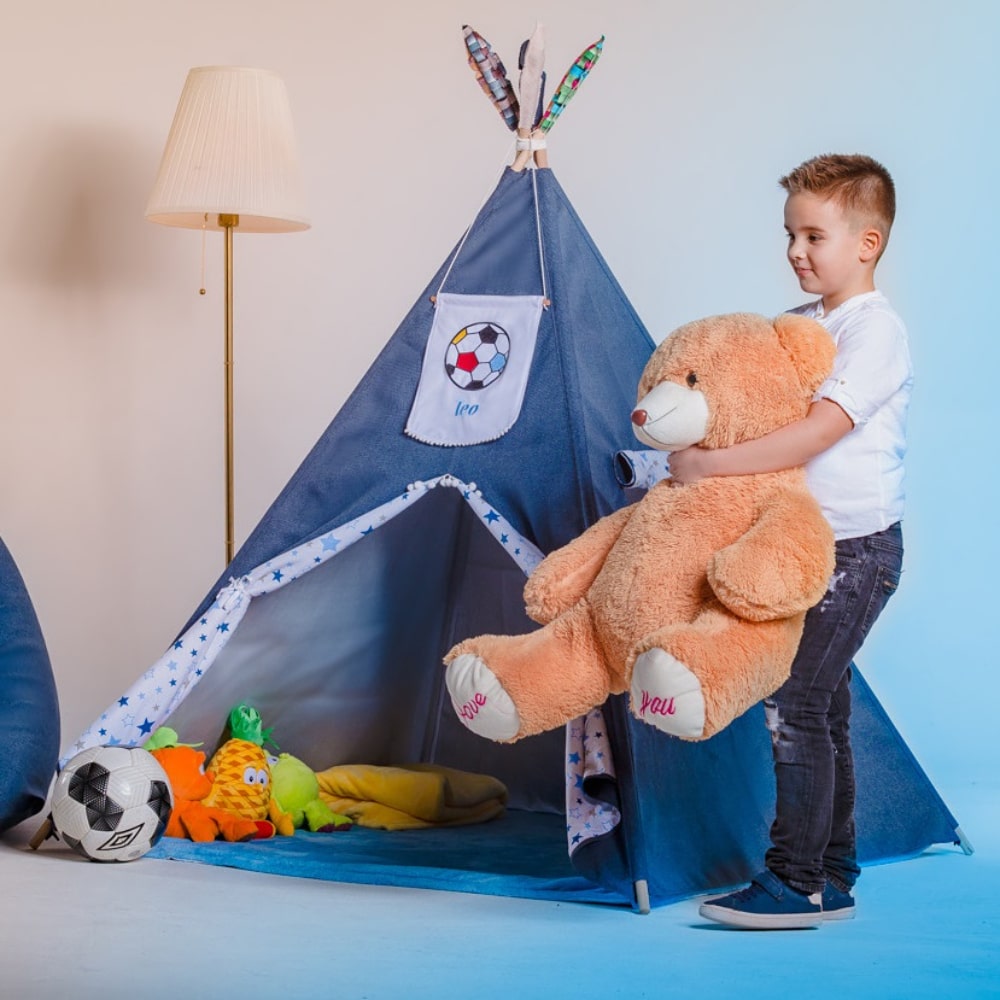 Boy kid enjoying his personalized teepee tent and playing in it