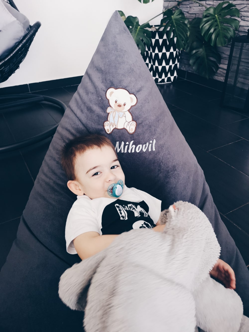Little boy sitting in a personalized bean bag and enjoying it